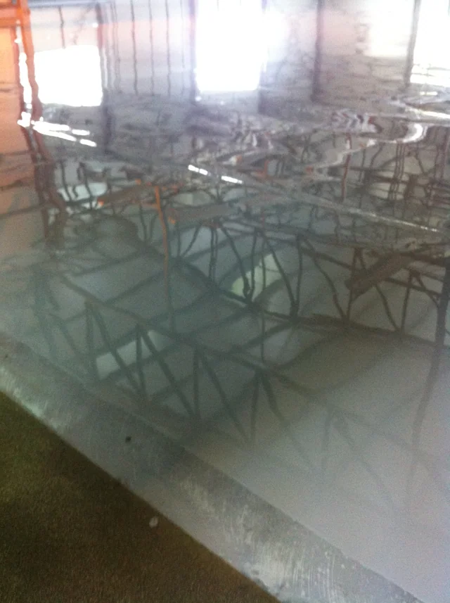 Hală metalică Călărași — Structura metalică reflectată în suprafața pardoselii în timpul lucrărilor interioare.